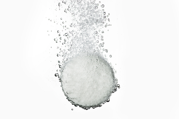 Cápsula efervescente formulada com bicarbonato de sódio, usada para tratar desconfortos estomacais.