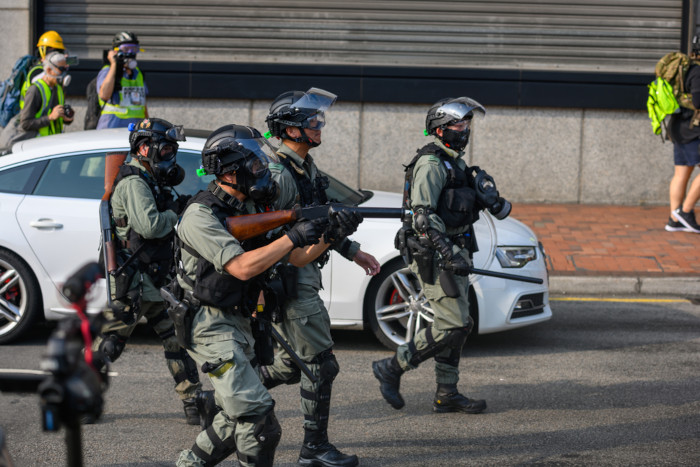 Policiais equipados com máscaras e óculos adequados para evitar contato com o gás lacrimogêneo. [4]