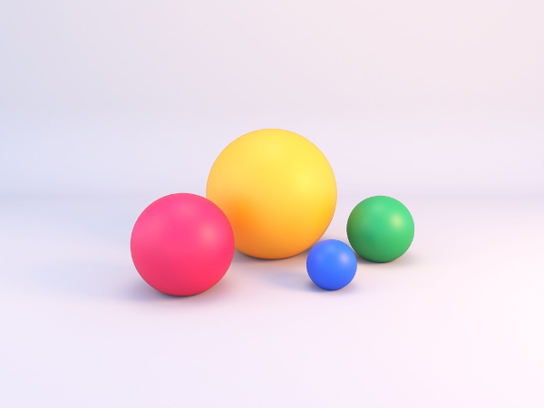 Quatro esferas coloridas sobre uma superfície plana.
