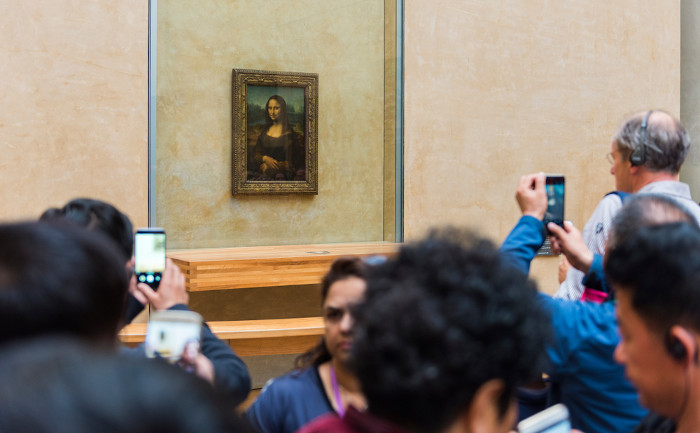 Turistas fotografando a “Mona Lisa”, obra mais famosa de Leonardo da Vinci, que está exposta no Museu do Louvre, na França.