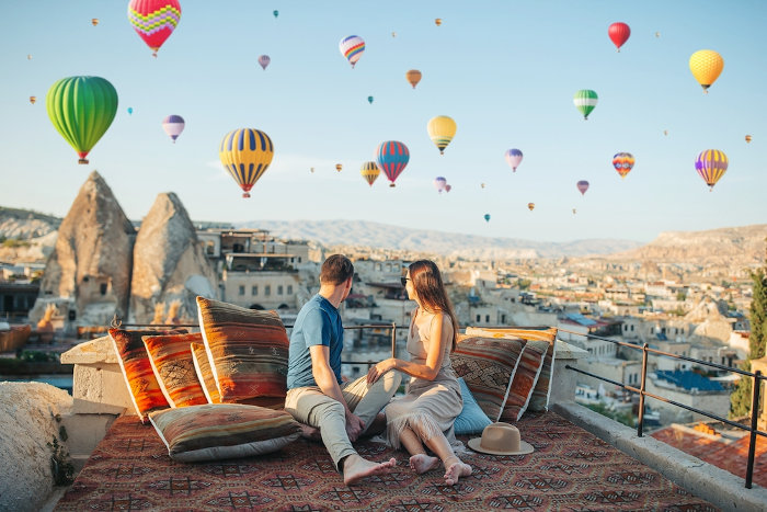 Turistas contemplando um festival de balões na Turquia.
