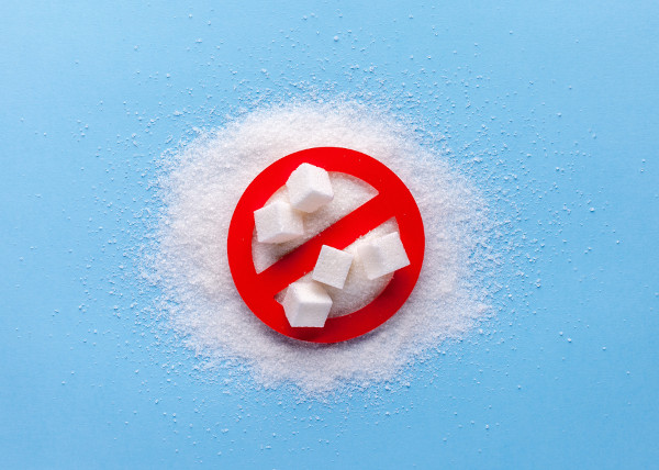 Monte de açúcar sob símbolo de proibição, em referência aos ricos do consumo de açúcar.