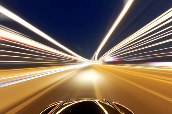 Veículo em movimento e luzes distorcidas em uma estrada, em alusão à velocidade da luz. Veículo em movimento e luzes distorcidas em uma estrada, em alusão à velocidade da luz.